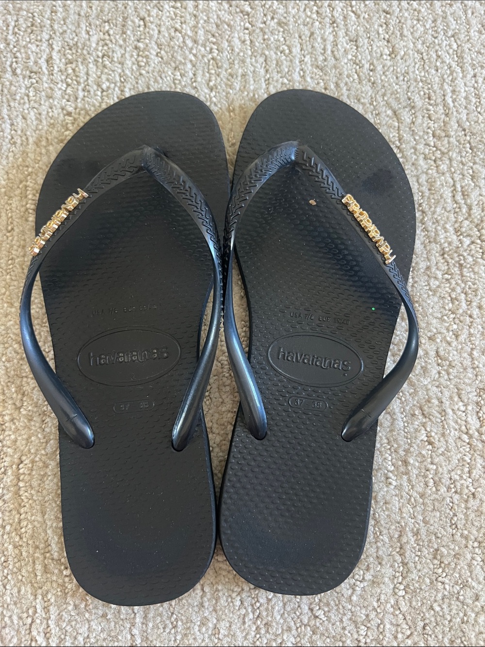 Havaianas Black Flip Flops with Gold Strap Logo